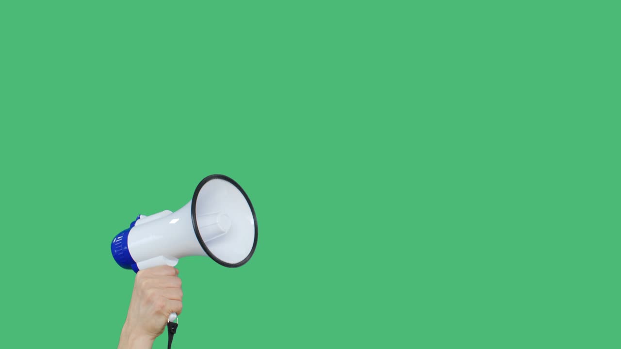Protester raising hand with megaphone on green background