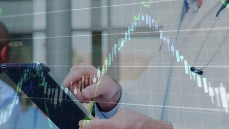 analyzing financial graph overlay, doctor using tablet for data review in office