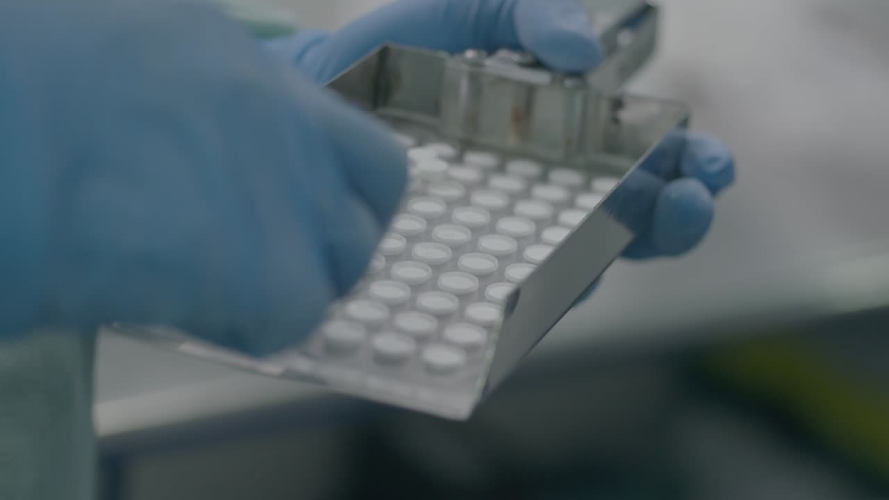 researcher selects the aspirins and places them in plastic-sealed blister packs, ensuring proper packaging and protection.