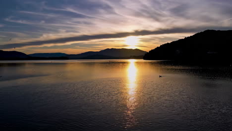 golden sunset and twilight reflections on a serene mountain lake