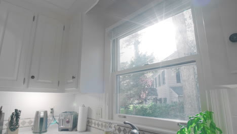 Gimbal-shot-of-and-empty-white-kitchen-in-the-suburbs