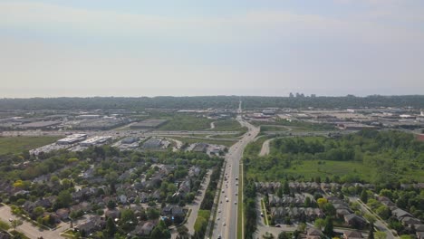 Drone-flying-over-Oakville-neighborhood-on-a-hazy-day-with-the-QEW-in-view