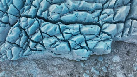 aerial top view of textured ice formations of a glacier in iceland, at dusk