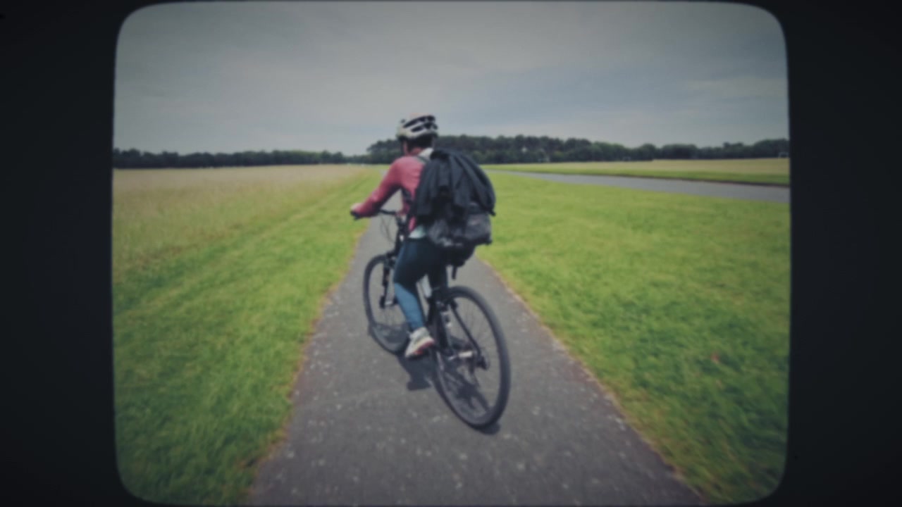 Woman riding a bike through the field