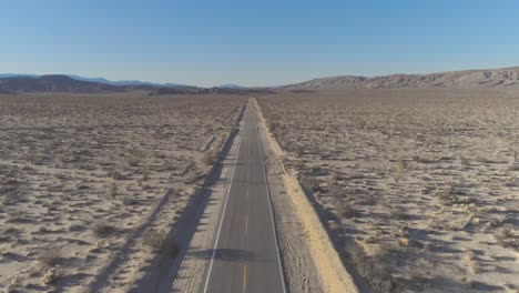 dji phantom 4 pro in the desert of southern california on an open road in between mountains