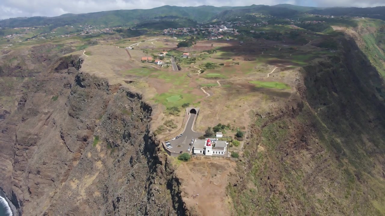 Khung cảnh xa xôi và yên bình của sân golf Ponta do Pargo. Được bao quanh bởi vách đá và đại dương, sân golf hiện ra như một ốc đảo xanh giữa phong cảnh núi lửa hiểm trở. Drone bay lùi.