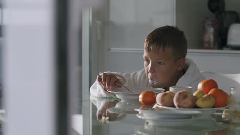 Hungry-child-having-a-lunch-at-home