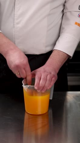 chef mixing orange sauce