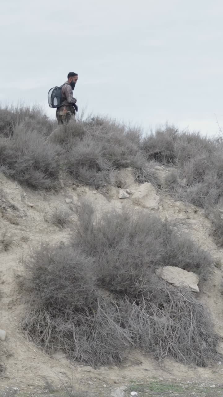 Man with backpack in arid landscape