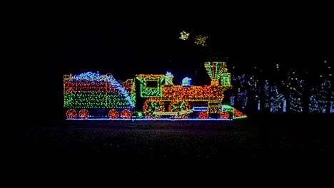 a view of an led steam train as a christmas display with moving wheels and smoke