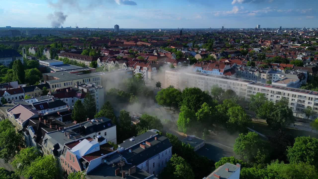 Yellow rescue helicopter landing in a Berlin urban park during a dust emergency. Best aerial view flight drone shot footage from above drone