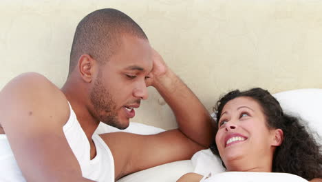 young couple discussing together on the bed