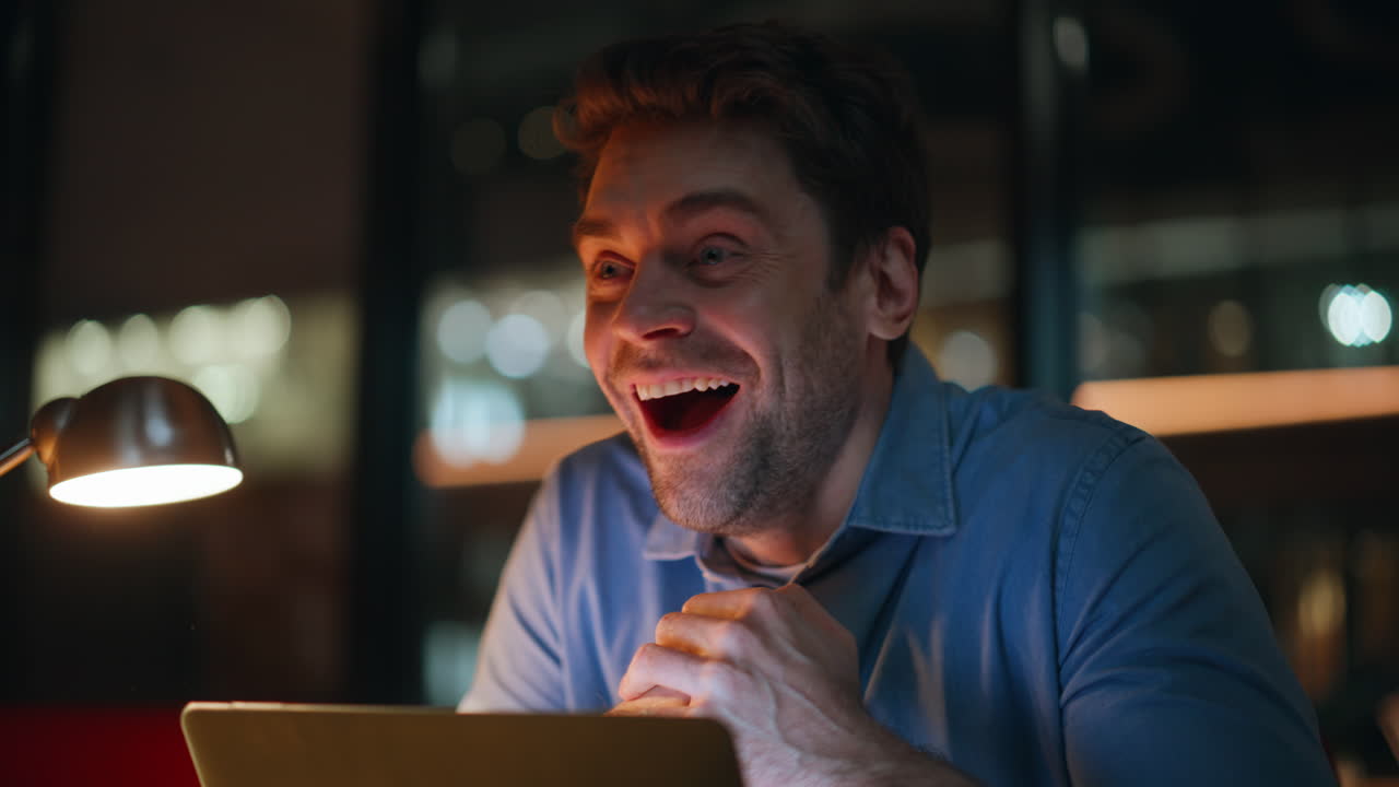 Happy programmer working night rejoicing successful project look laptop closeup