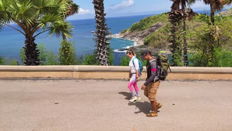 couple hiking along scenic coastal path