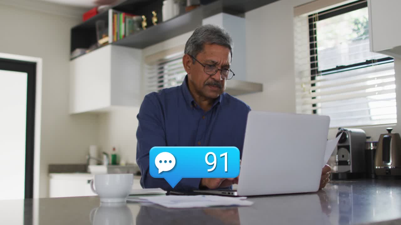 Animation of emoji icons over man using laptop