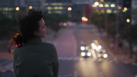 portrait young woman relaxing enjoying night life in scenic urban cityscape watching traffic happy independent female in evening city slow motion lights bokeh