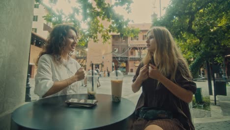 two women enjoying bubble tea and conversation