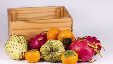 hands placing fruit into a wooden crate