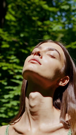 woman enjoying sun's warmth outdoors