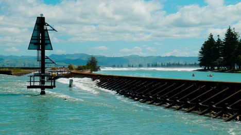 Capture-the-mesmerizing-spectacle-of-powerful-waves-relentlessly-crashing-against-a-rugged-harbour-wall,-showcasing-the-raw-beauty-and-force-of-nature's-unyielding-power