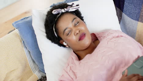 african american woman sleeps peacefully on a couch at home