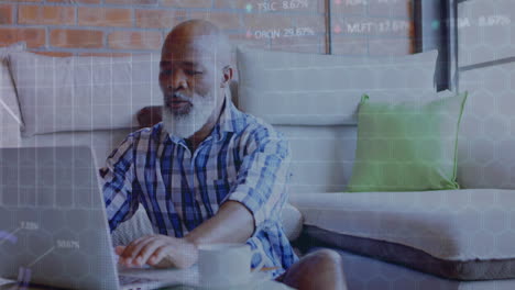 Animation of financial data processing over senior african american man using laptop