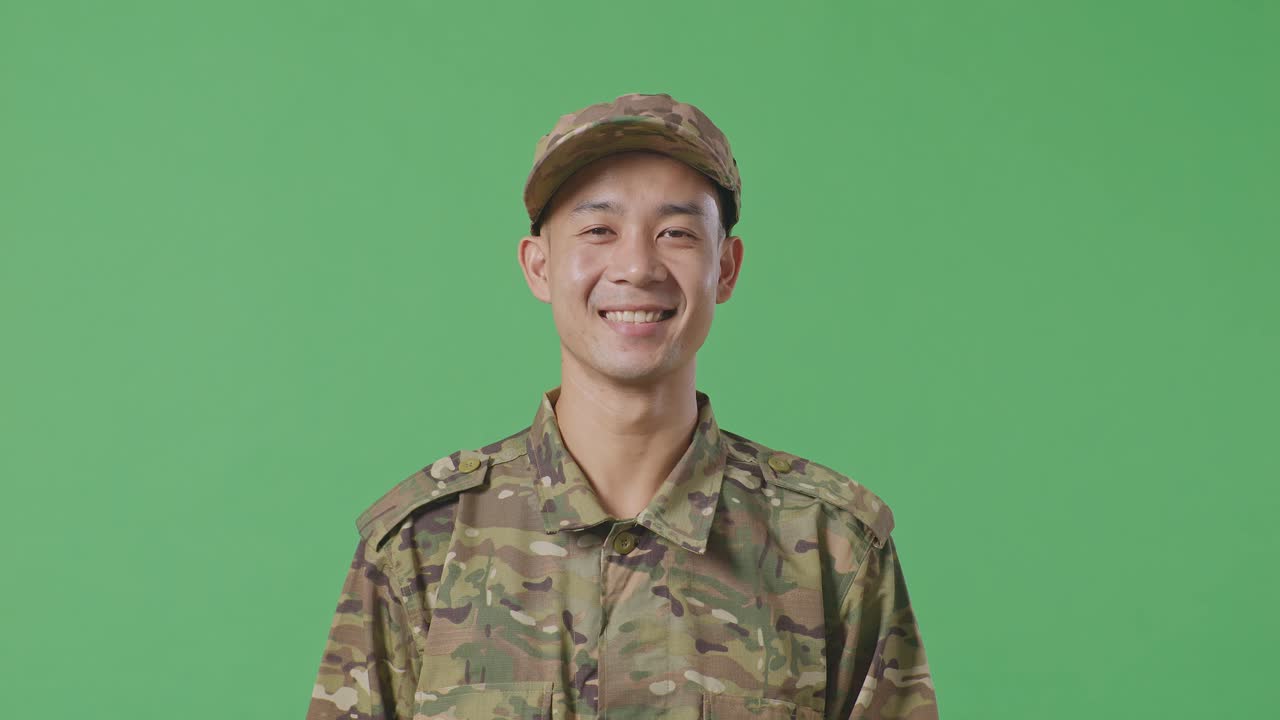 Close Up Of Asian Man Soldier Standing And Smiling To Camera In The Green Screen Background Studio