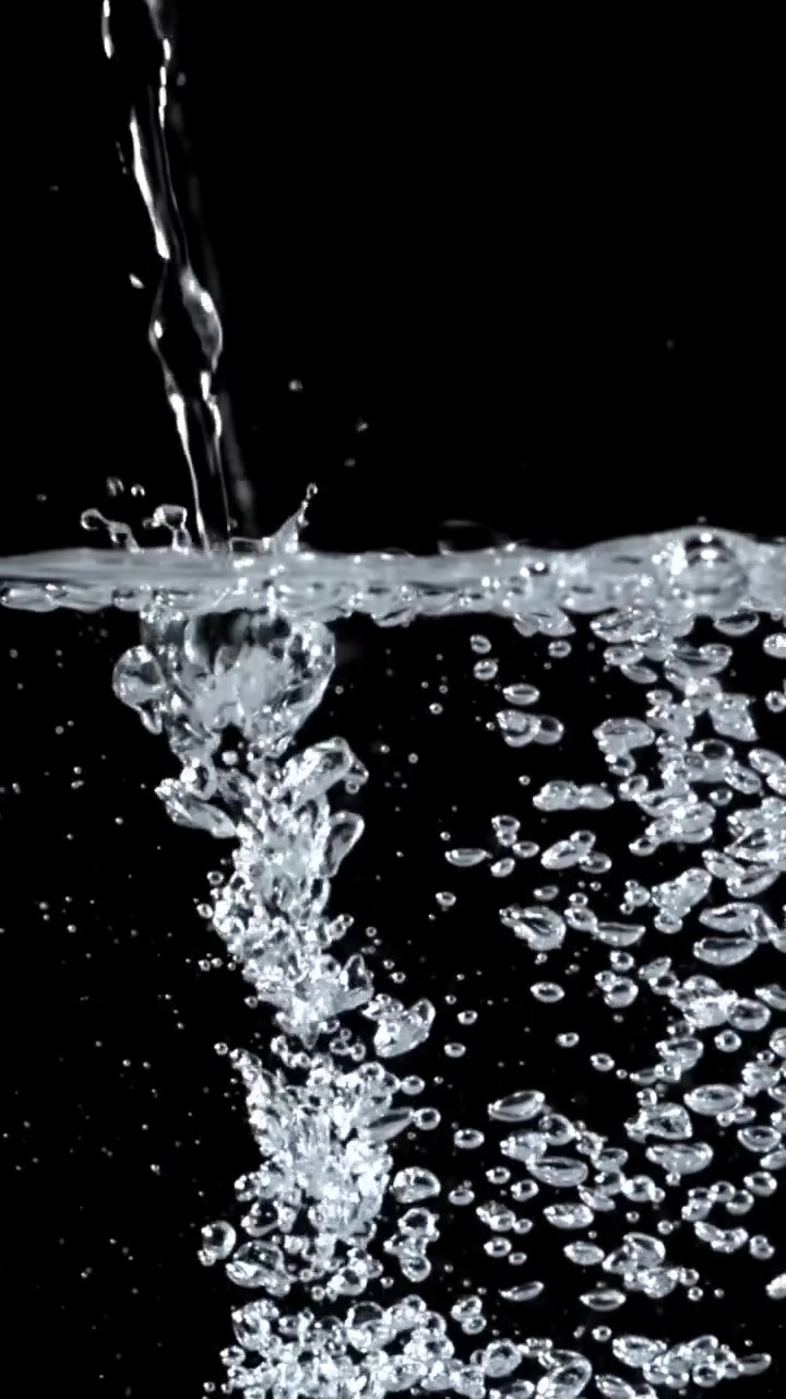 Clear Water Pouring and Bubbling on a Black Background