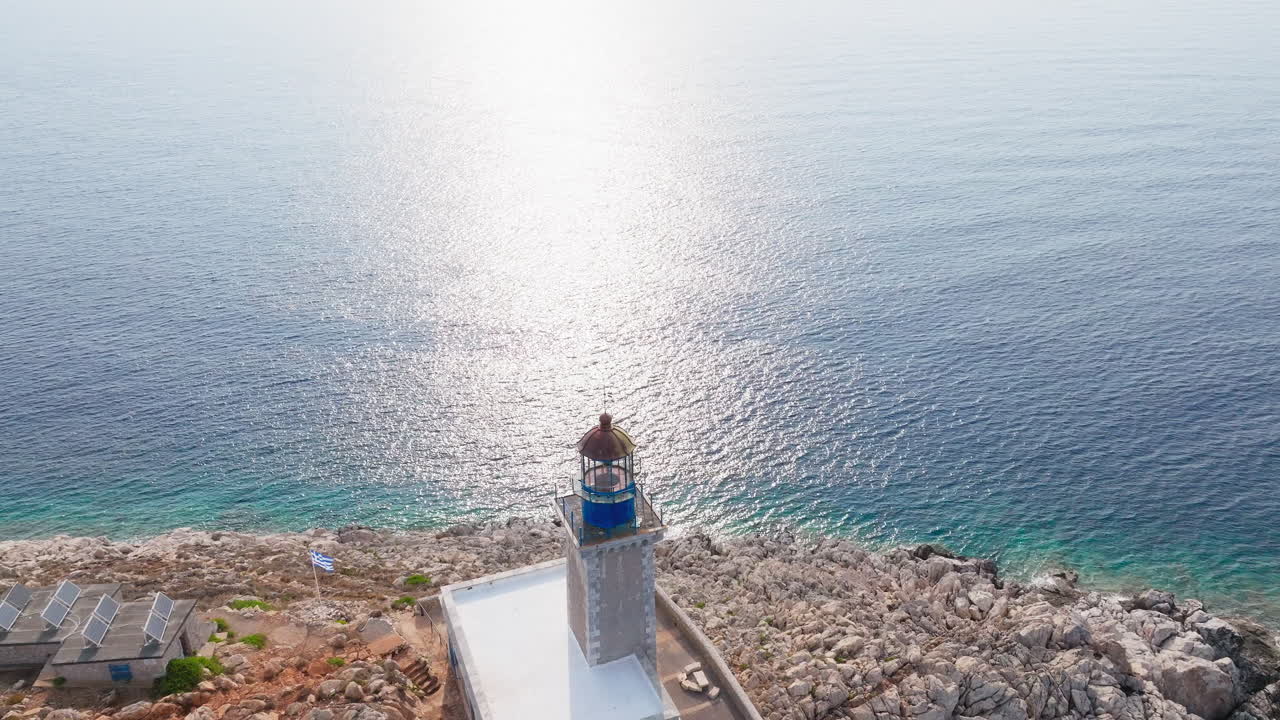 Drone glides across sparkling sea surface near Cape Tainaron, sunlight reflects off blue water