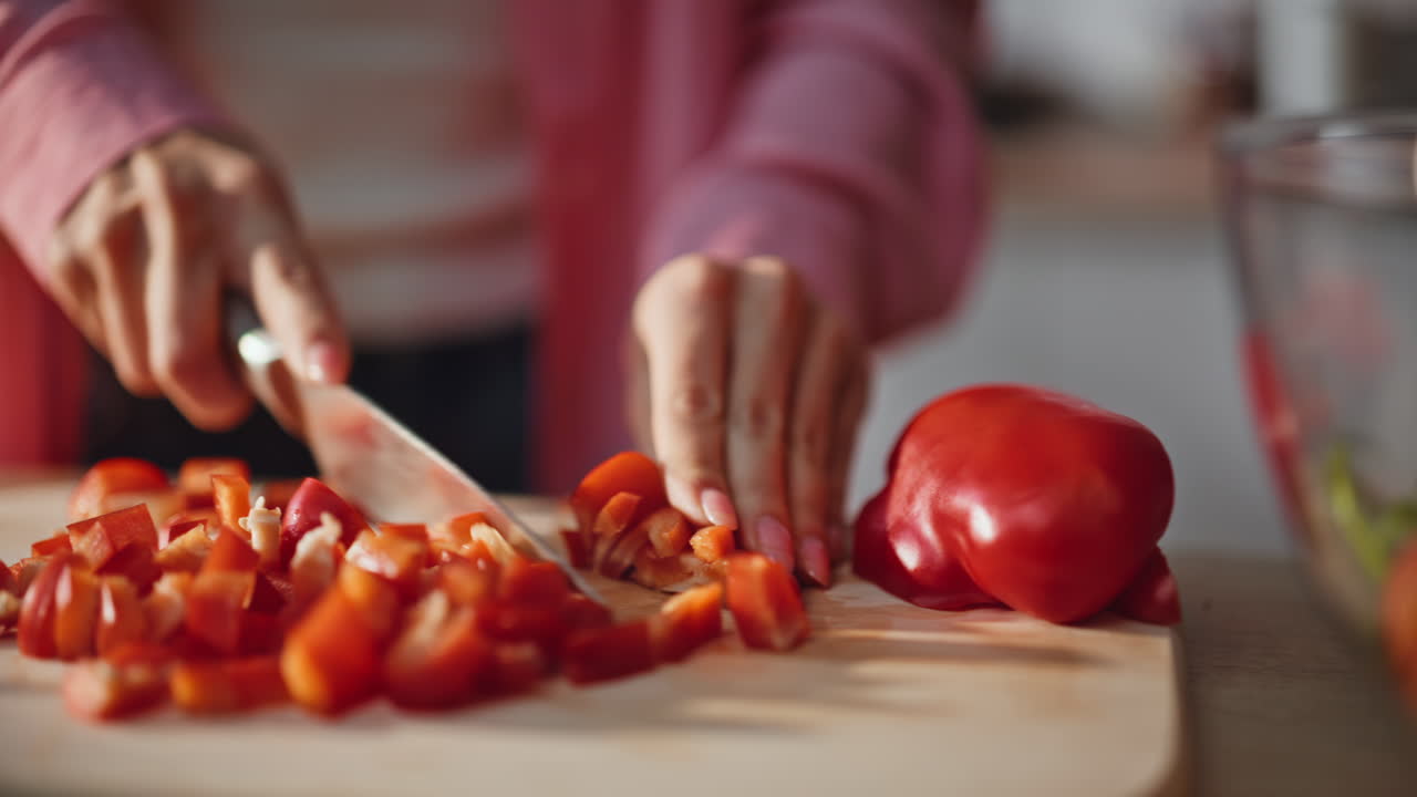 Unknown woman slicing vegetables chopping board kitchen closeup. Hands cutting
