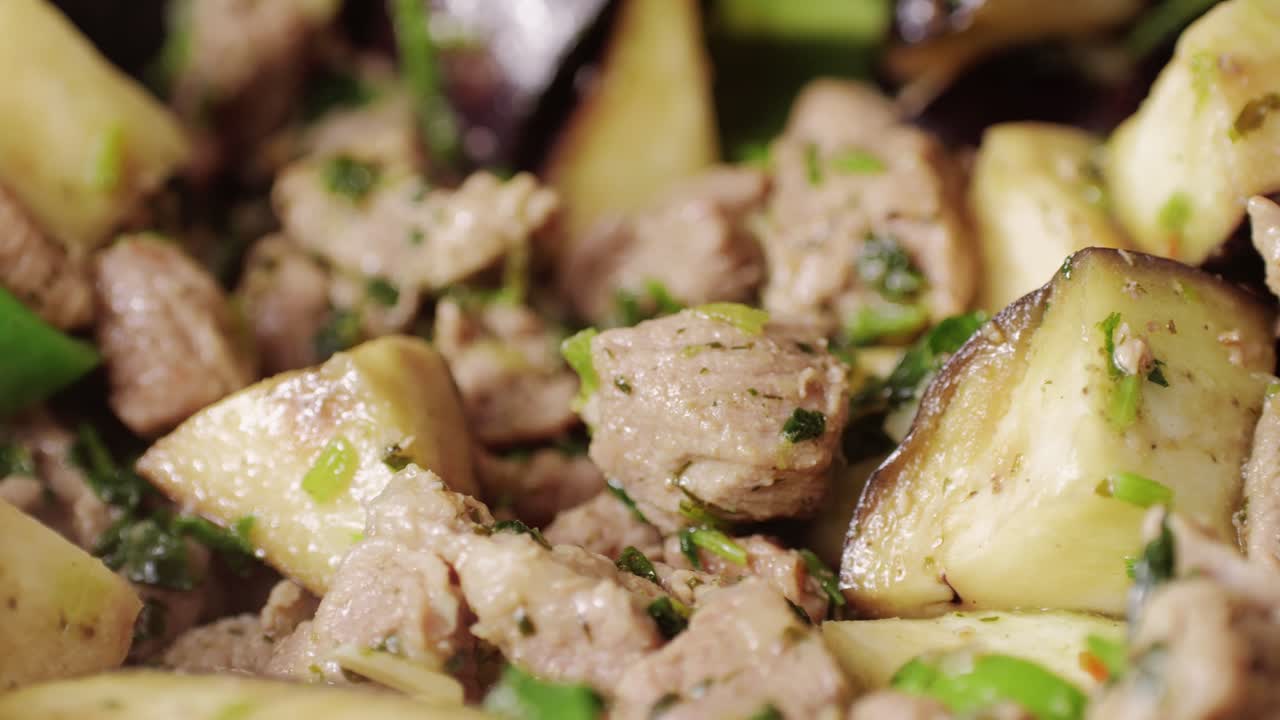 Chicken or pork stew with red and green pepper onion, and spices cooking in a frying pan. Traditional mexican cuisine, tacos preparation, ragout.