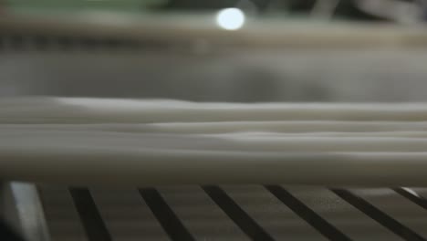 macro shot of cotton being spun on a industrial spinning machine