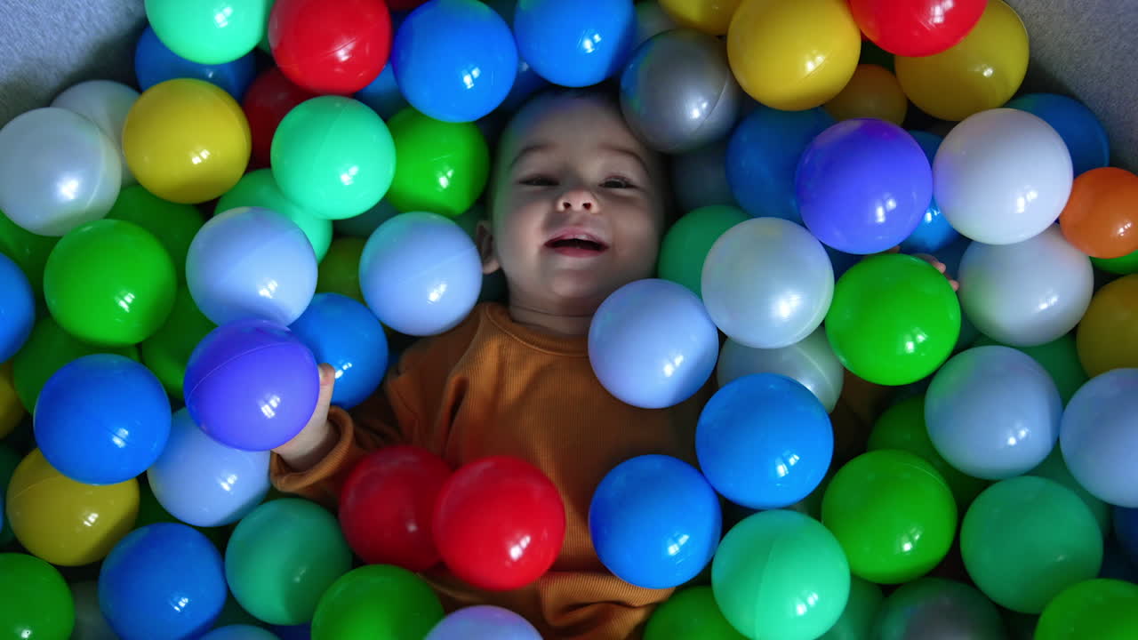Baby having fun in a ball pit