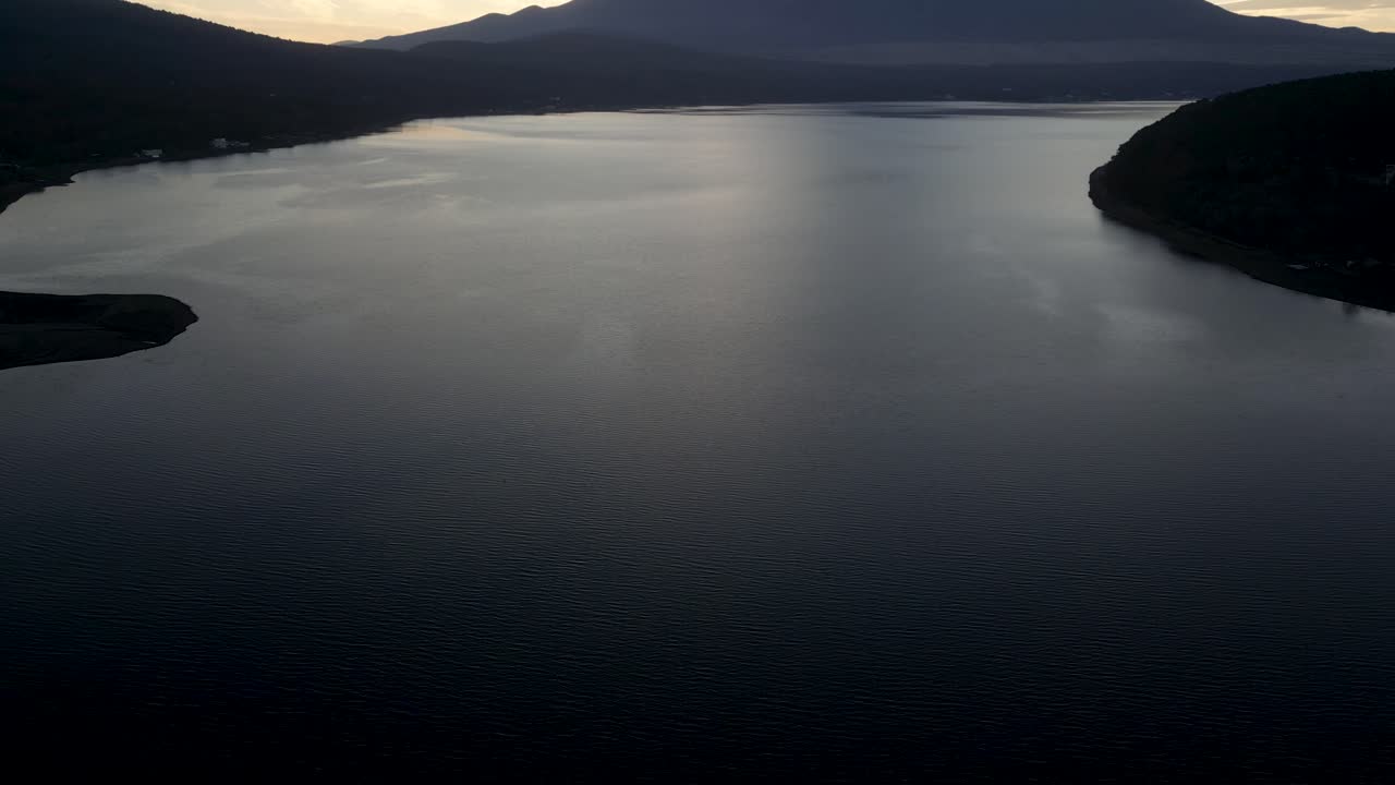 Slow motion drone tilt up shot over Lake Yamanakako in Yamanashi