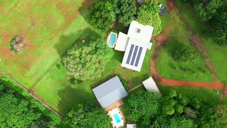 aerial drone of rural block with dual living homes on large property, top down pan