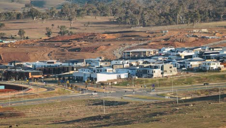 glowing morning sun lights up a developing suburb in canberra with building pads and road infrastructure