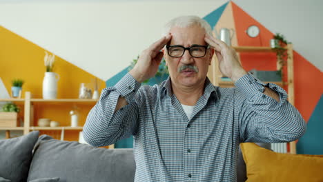 senior man with headache