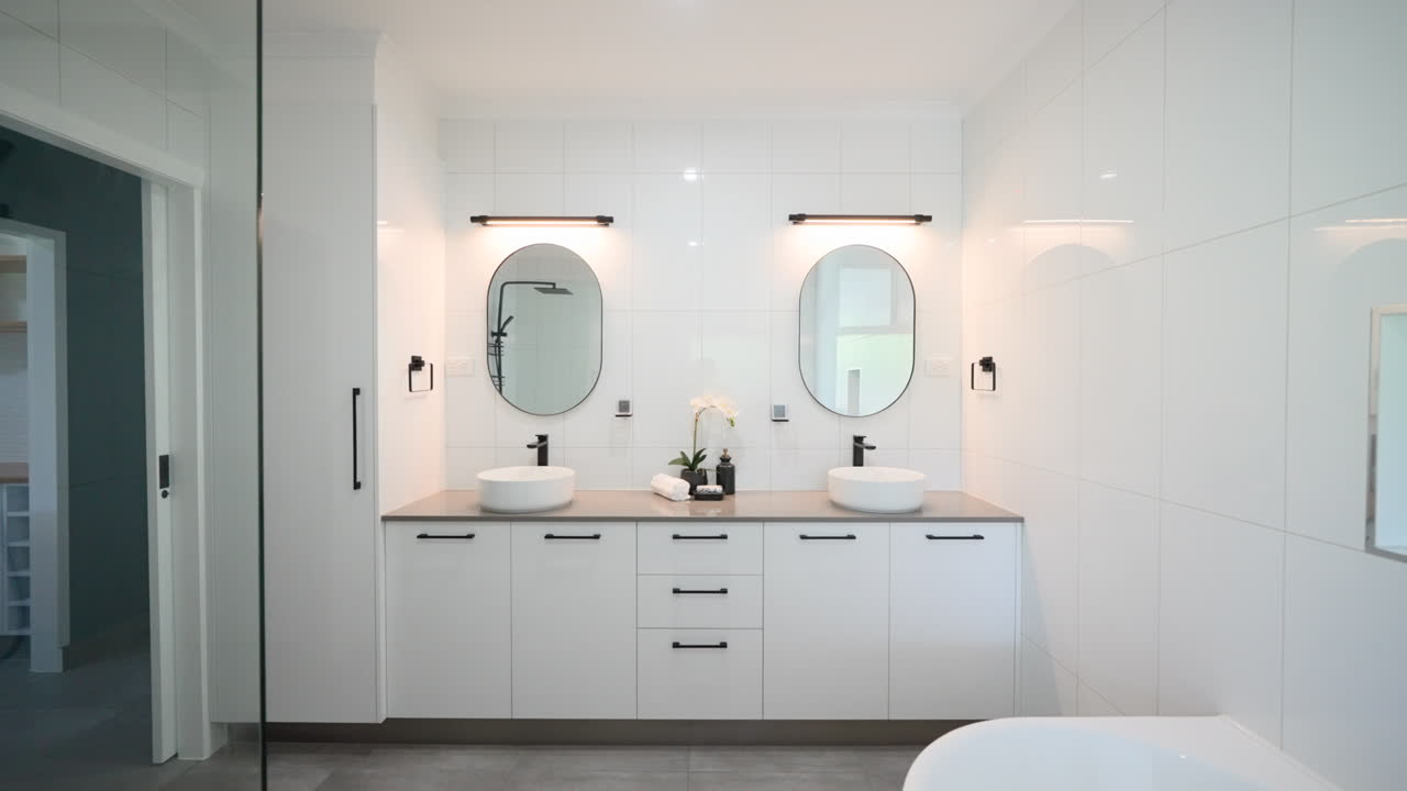 Minimalistic Luxury Double Dual Vanity Bathroom with Modern Appliances and Individual Counter Spaces