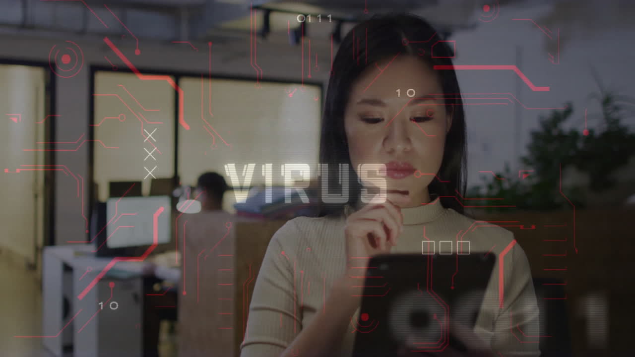 woman tapping tablet in technology office, man working desktop while virus graphics floating around