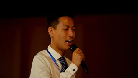 Young-Asian-businessman-speaking-in-business-seminar-at-auditorium-4k