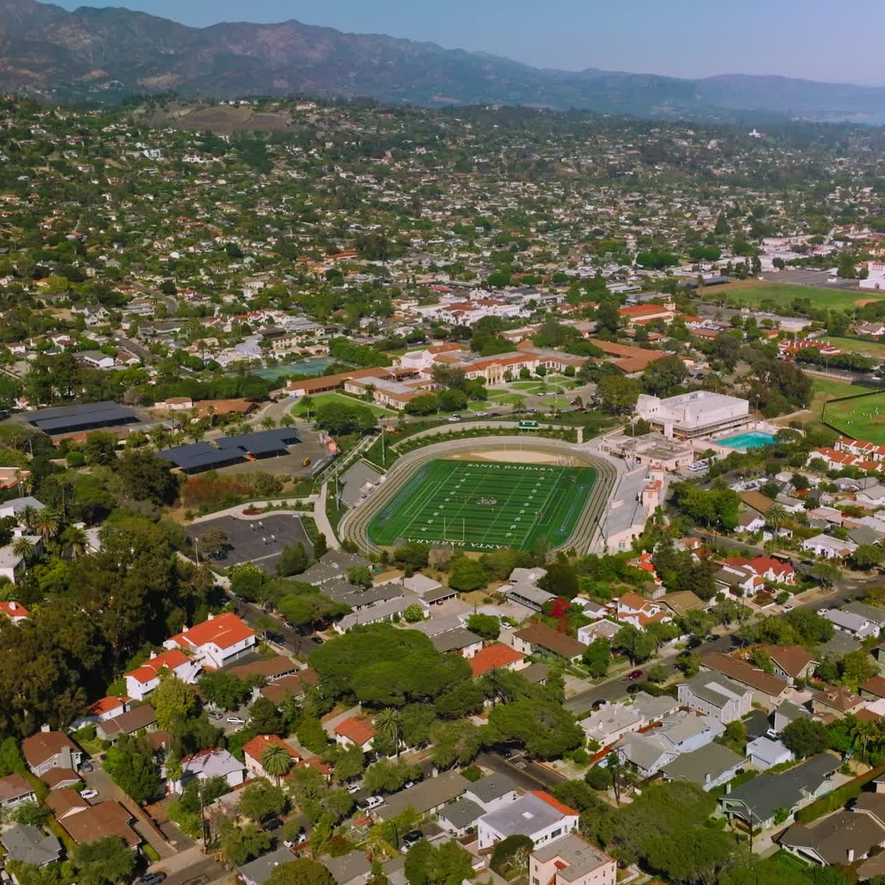 Sunny view of Santa Barbara, California, USA. Amazing beautiful green city from aerial perspective. Mountains at backdrop