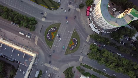 aerial view of city intersection with roundabout and buildings