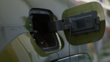 Close Up Of Person Opens Vehicle Inlet Port Of Ev Eco Friendly Car To Charge It