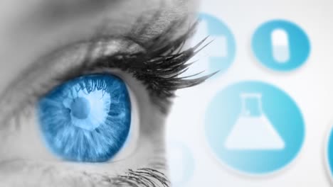 Close-up-of-female-blue-eye-against-medical-icons-on-white-background