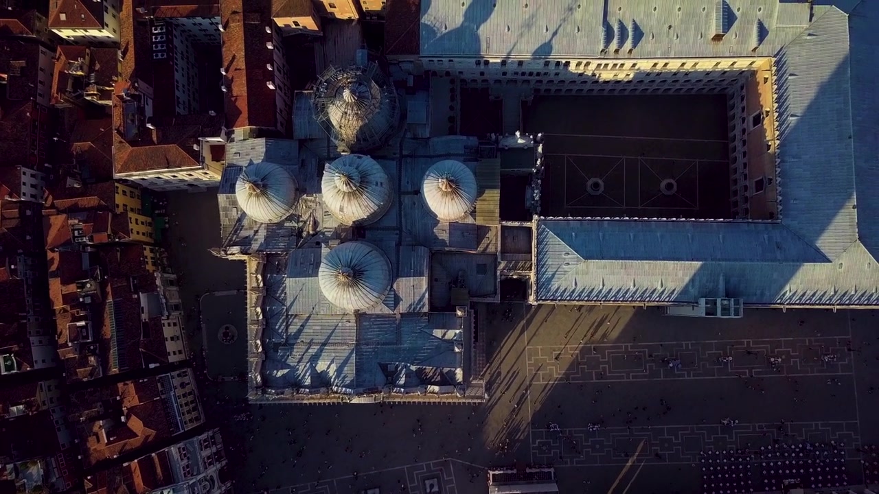 The drone advances in a top down view over the Basilica di San Marco domes.