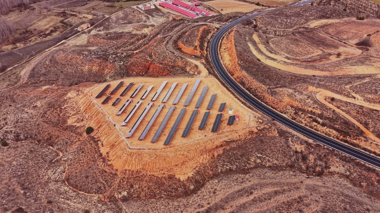 Solar panels placed in a field near a road in Spain