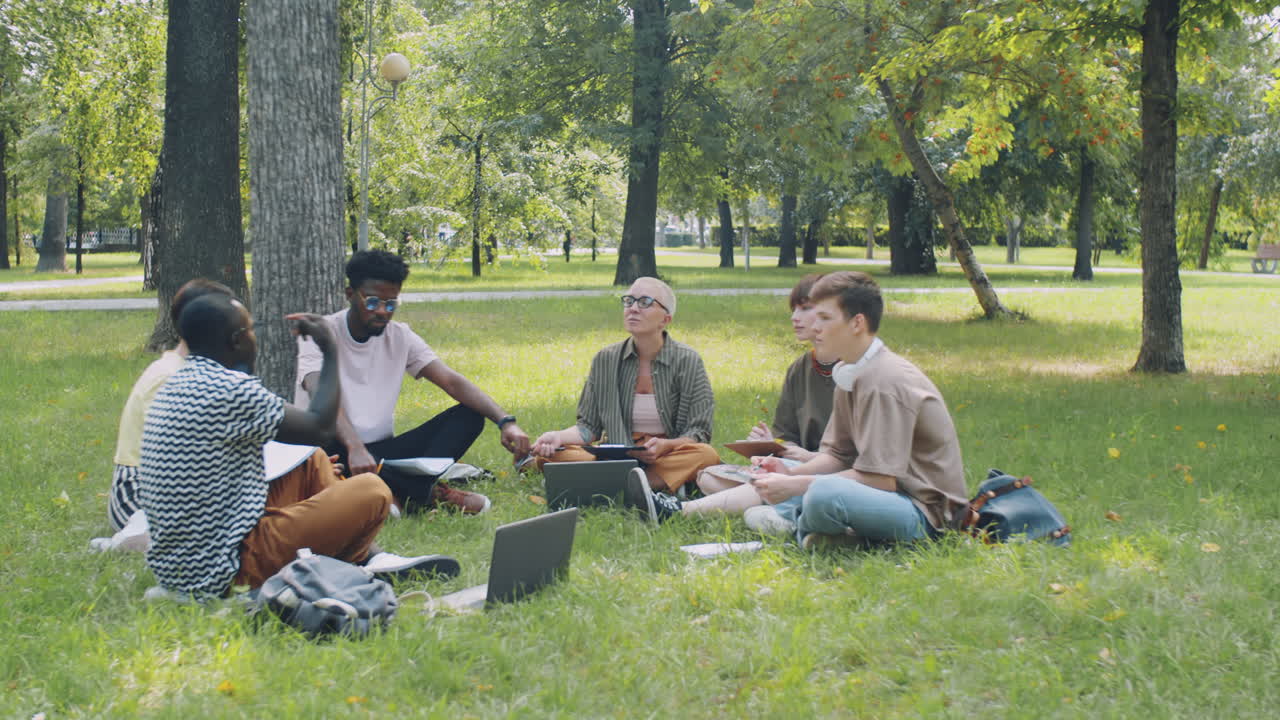 Multiethnic College Students and Teacher Speaking at Outdoor Lesson