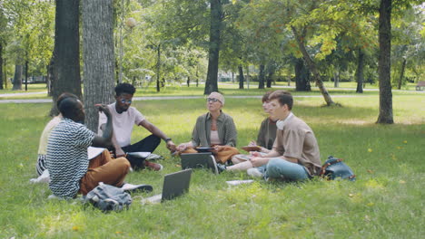 multiethnic college students and teacher speaking at outdoor lesson