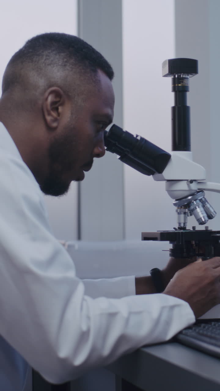 Scientist using a microscope in a laboratory setting