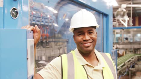 smiling worker operating a machine